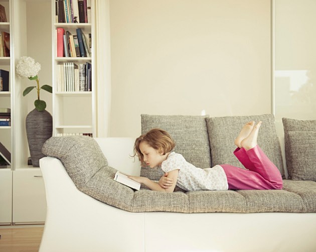 young girl reading on couch young girl reading on couch